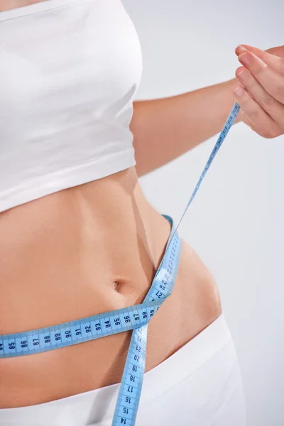 Woman measuring waist of perfect body — Stock Photo, Image
