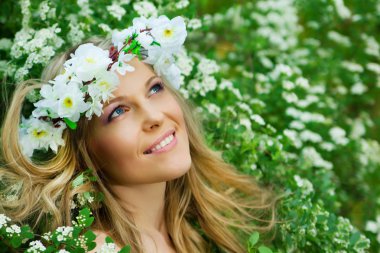 Portrait of the young smiling beautiful woman outdoors clipart