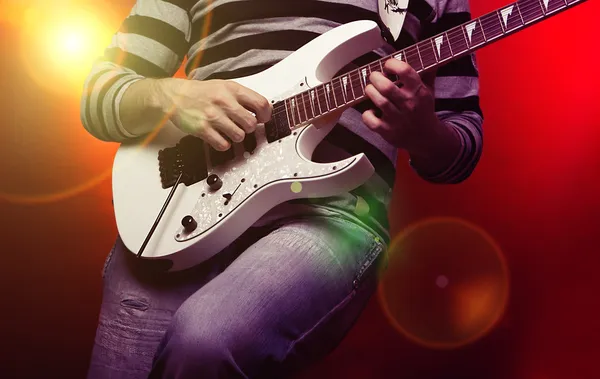 Young male musician with a white guitar — Stock Photo, Image