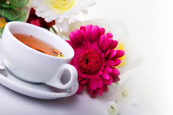 Xícara de chá com flor na mesa — Fotografia de Stock
