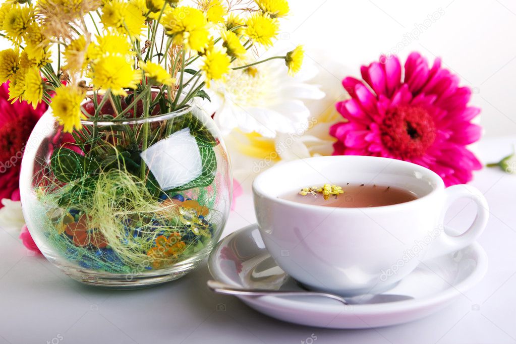Cup of tea with flower on table