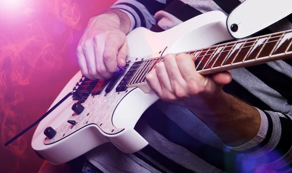 Young male musician with a white guitar — Stock Photo, Image