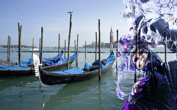 stock image Venetian masks against gondolas