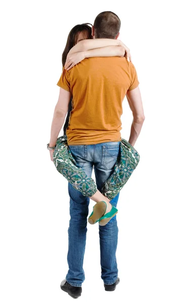 Vista do jovem casal heterossexual abraçando traseira. — Fotografia de Stock