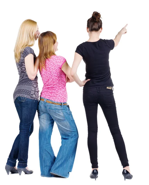 Back view of group beautiful women pointing at wall. — Stock Photo, Image