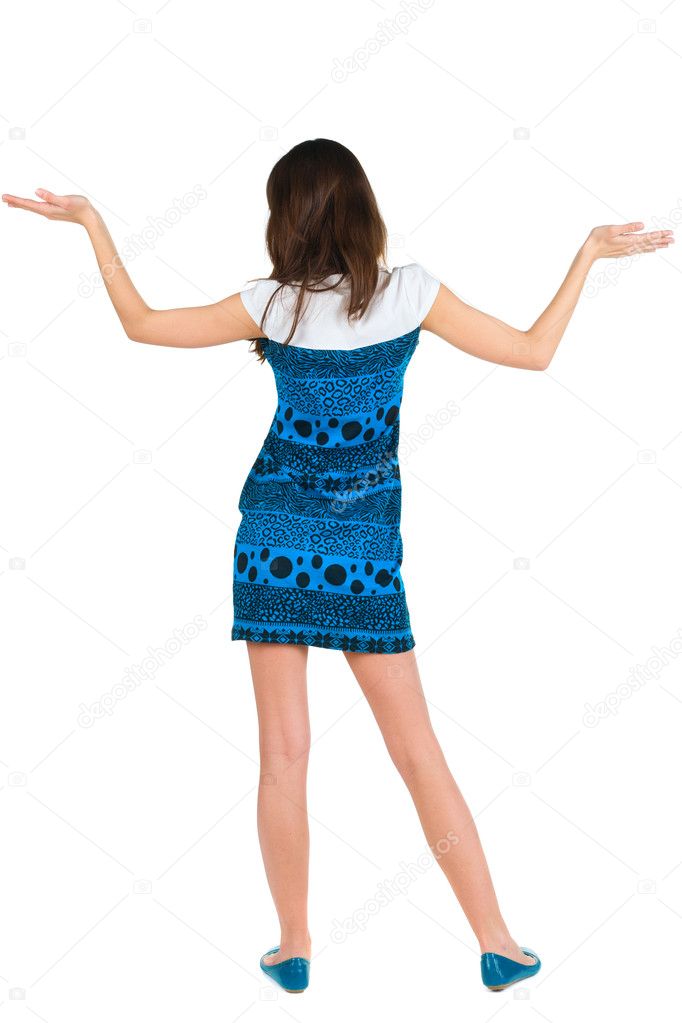 Back view of surprised brunette woman with hands up.