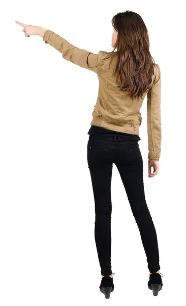 Back view of young brunette woman pointing — Stock Photo, Image
