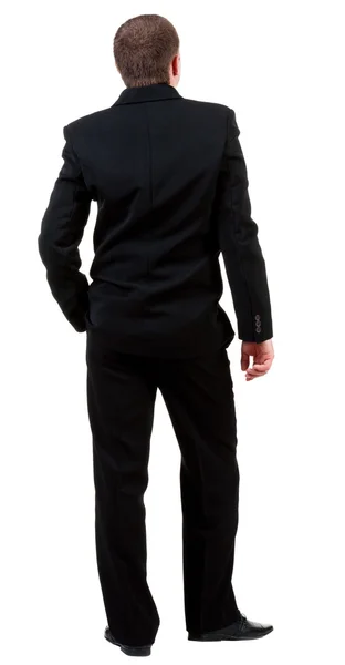 Achteraanzicht van jonge kerel in zwart pak kijken. — Stockfoto