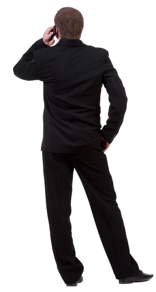 Вид сзади деловой человек в черном костюме, говорить на мобильном телефоне — стоковое фото