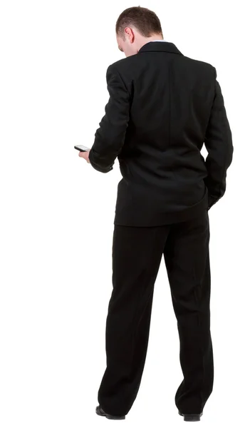 Vista posteriore di un uomo d'affari in abito nero parlando sul mobile phon — Foto Stock