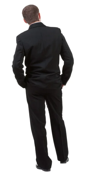 Rückansicht der Geschäftsmann sieht voraus. junger Mann im schwarzen Anzug Stockbild