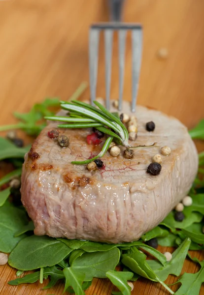 Cooked piece of beef on arugula salad — Stock Photo, Image