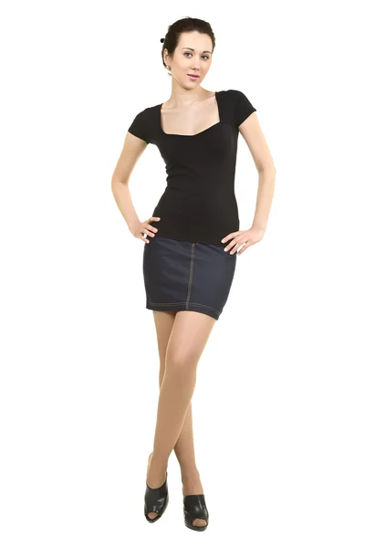 Attractive woman in a black shirt and denim skirt on a white bac — Stock Photo, Image