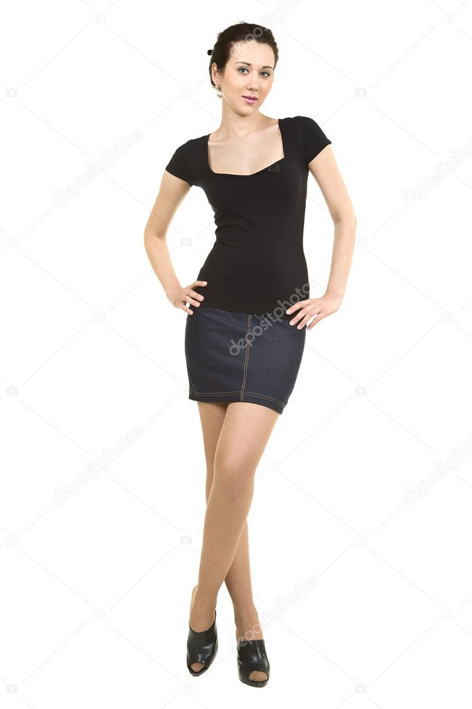 Attractive woman in a black shirt and denim skirt on a white bac