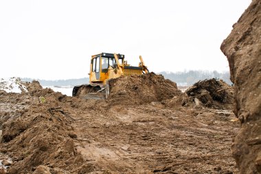 A yellow bulldozer working clipart