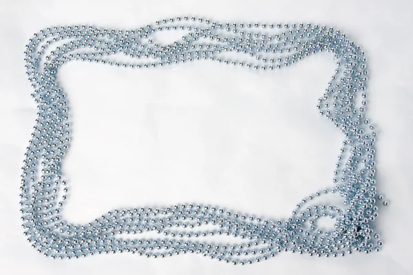 stock image Blue beads on a light blue background with space for text