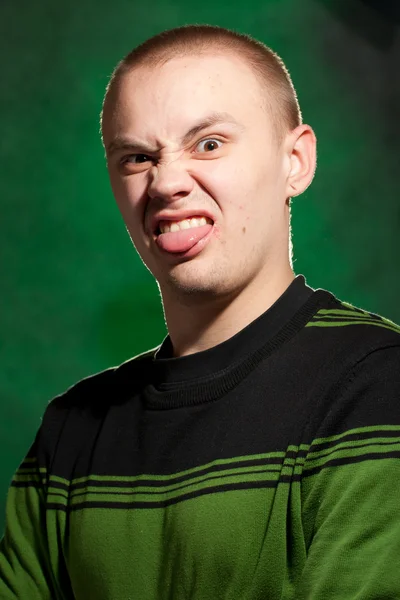 Portrait of the teenager on a green background in green clothes — Stock Photo, Image