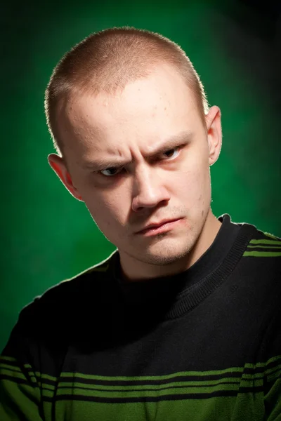 Portrait of the teenager on a green background in green clothes — Stock Photo, Image