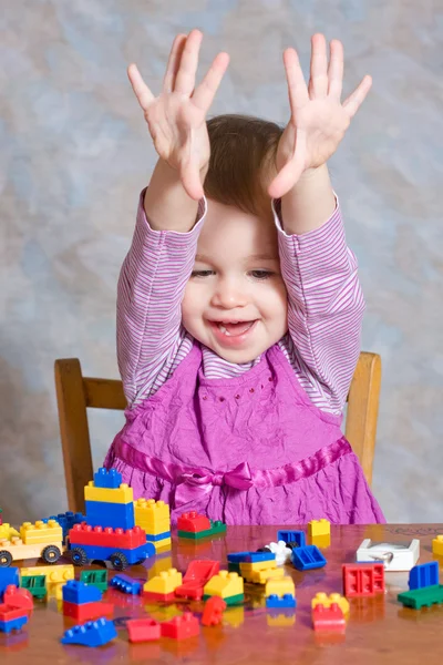 Ребенок в розовом платье с игрушками — стоковое фото