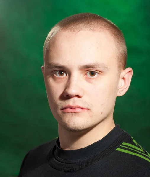 stock image Portrait of the teenager on a green background in green clothes