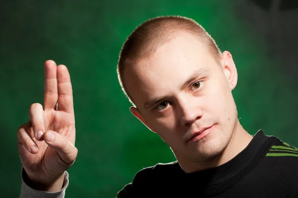 Stock image Portrait of the teenager on a green background in green clothes