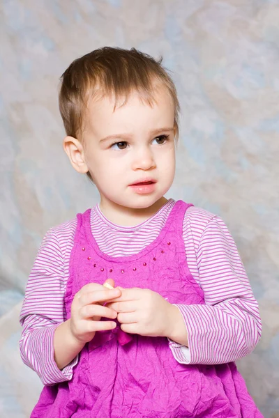 Het kind in een roze jurk — Stockfoto