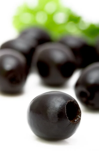 Black olives on a plate closeup, focus on foreground Stok Resim