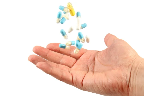 En hånd med medicinske piller - Stock-foto