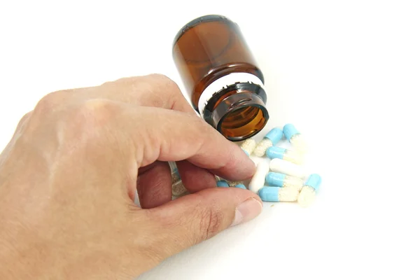Una mano con le pillole — Foto Stock