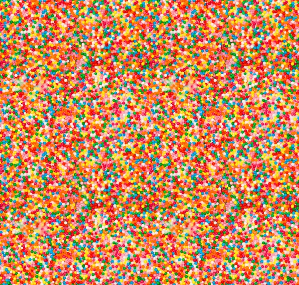 Sfondo senza cuciture: spruzzi di caramelle colorate — Foto Stock