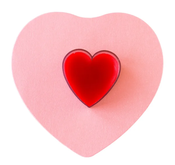 Красное сердце на розовом сердце — стоковое фото