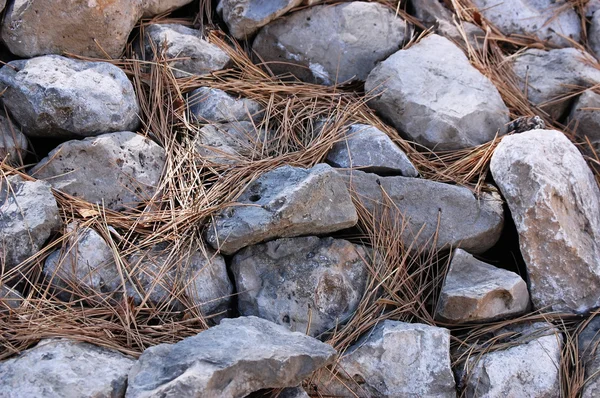 Pedras e fundo de palha — Fotografia de Stock