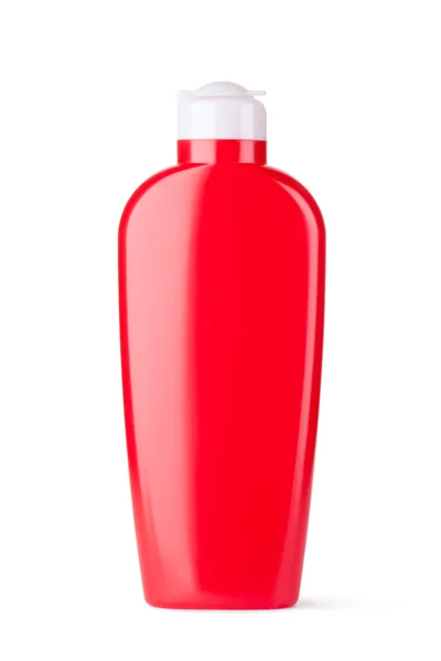 Красная пластиковая бутылка для косметики — стоковое фото