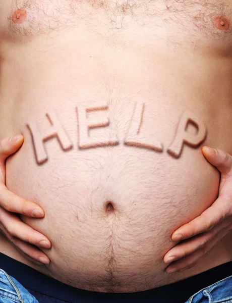 Man's maag met een uitsteekt inscriptie help — Stockfoto