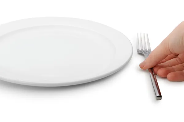 La mano pone tenedor a un plato — Foto de Stock