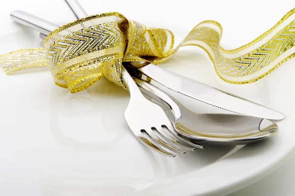 Cuillère, fourchette et un couteau attachés ruban de célébration — Photo