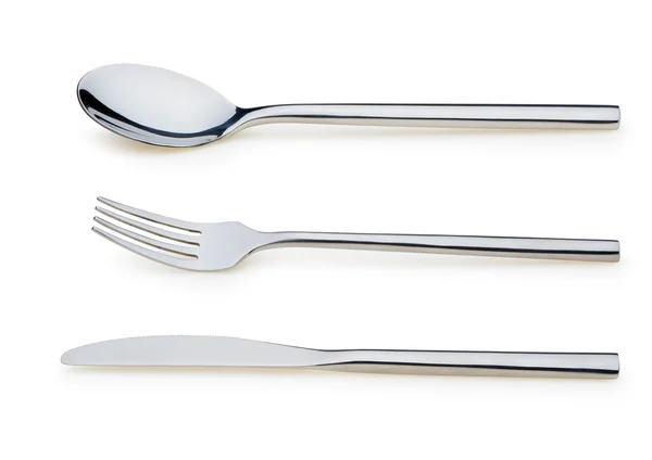 Colher, garfo e uma faca estão em um prato — Fotografia de Stock