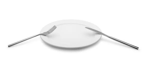 Fork and a knife lie on a plate — Stock Photo, Image