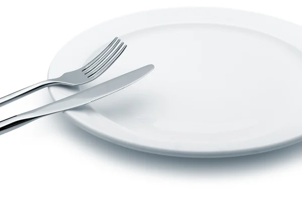 Cuchara y tenedor en un plato —  Fotos de Stock
