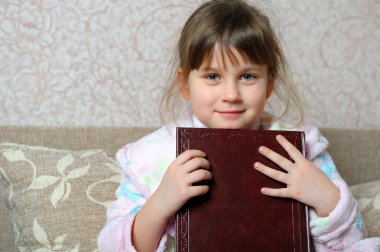 The little girl with the book clipart