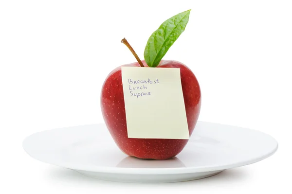 Manzana con notas de papel aisladas en blanco — Foto de Stock