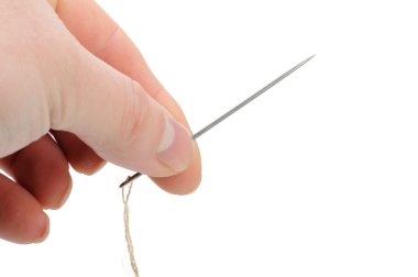 Needle and thread in hand closeup clipart