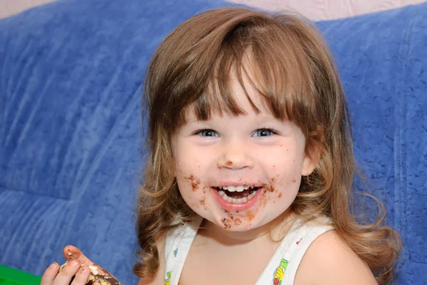 stock image The little girl eats a cake