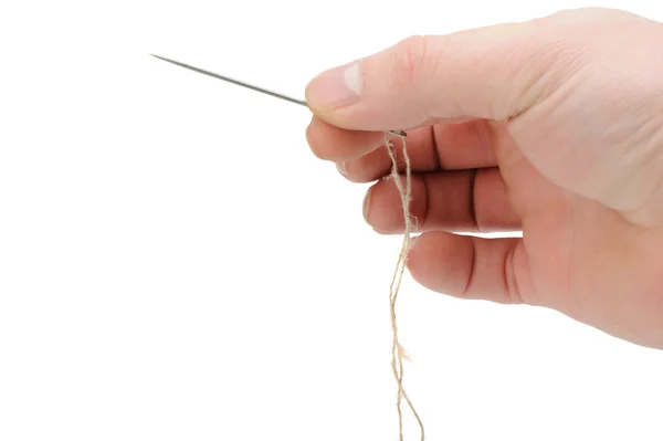 Needle and thread in hand closeup — Stock Photo, Image
