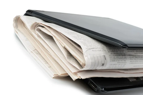 Newspaper and a laptop — Stock Photo, Image