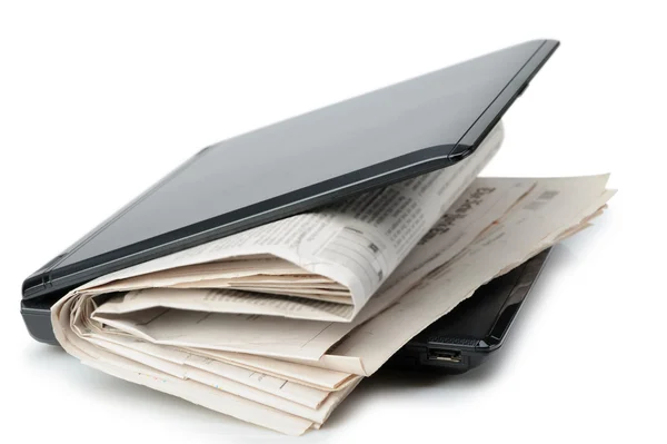 Newspaper and a laptop — Stock Photo, Image