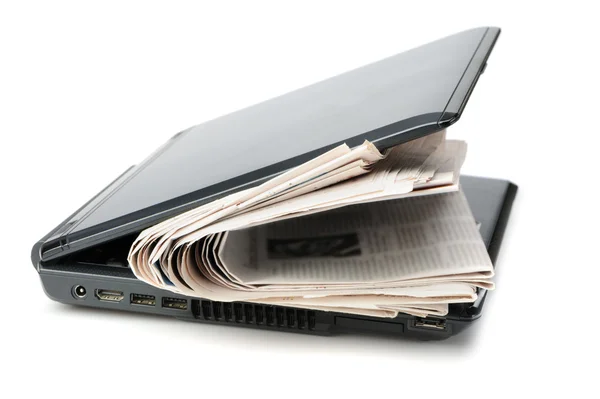 Newspaper and a laptop — Stock Photo, Image