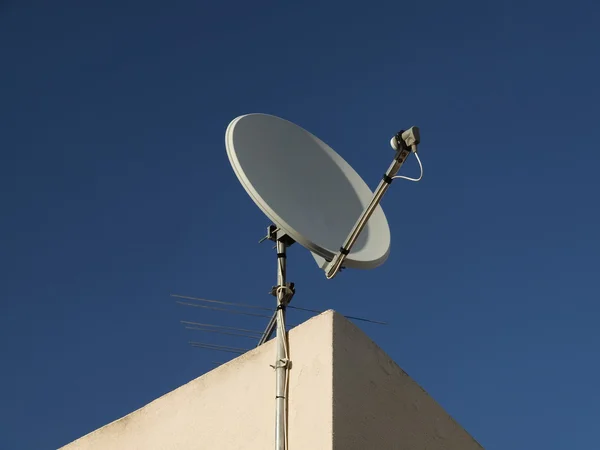 stock image Satellite dish, Rooftop dish with blue sky