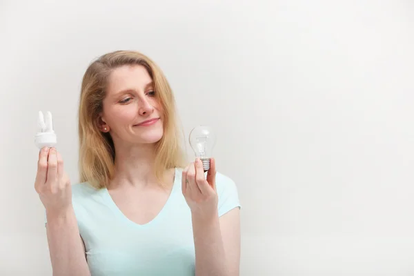 Woman choosing a light bulb