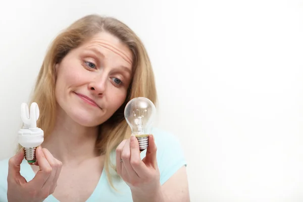 stock image Pretty Blonde Comparing Lightbulb Technologies